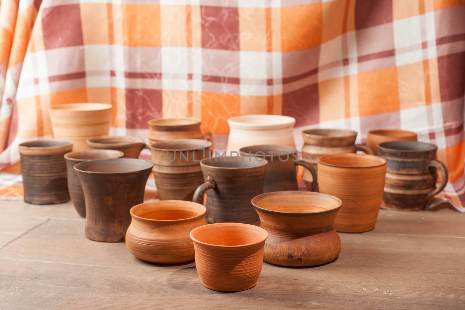 Set of traditional handcrafted mugs on the wooden table