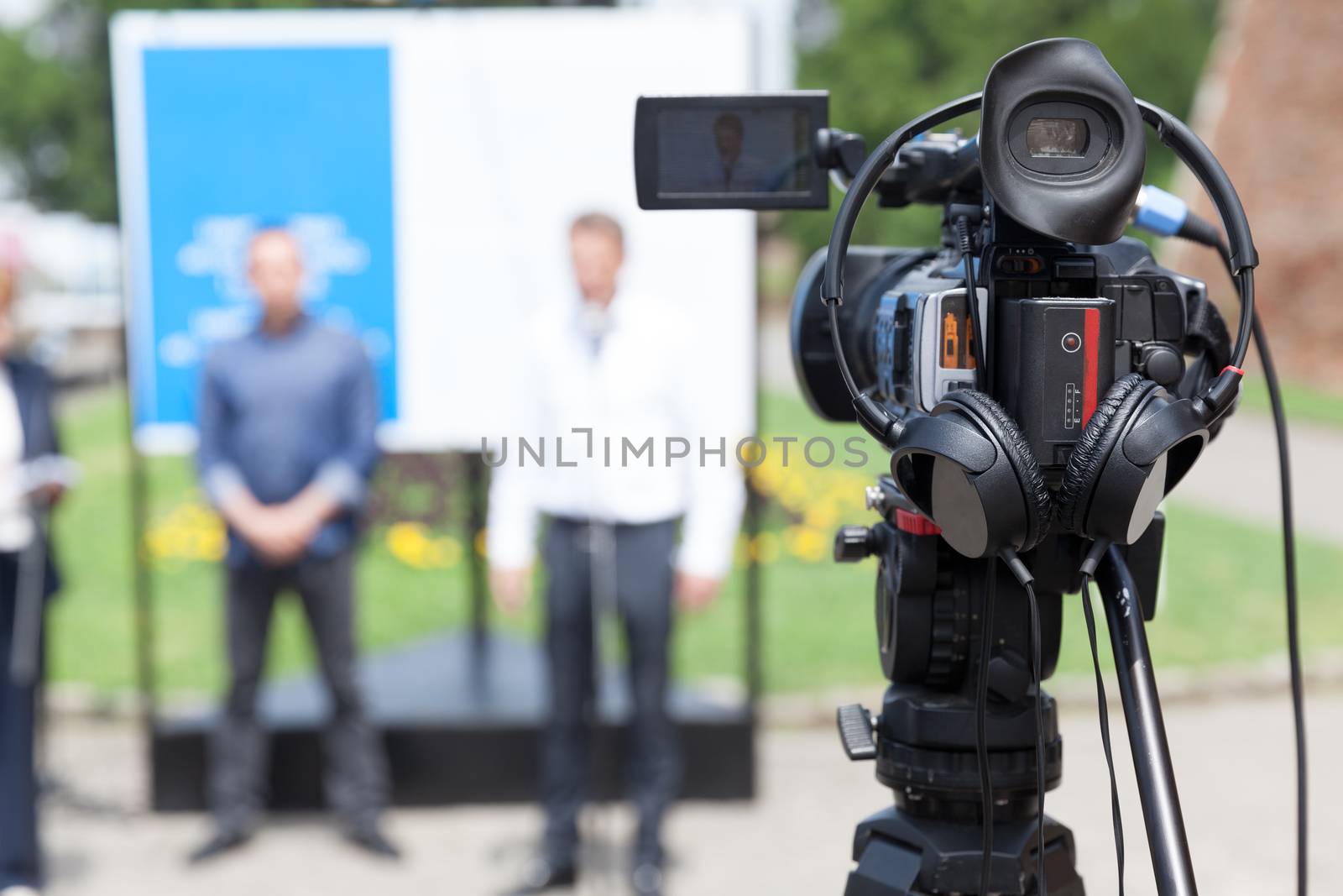 Filming an media event with a video camera by wellphoto