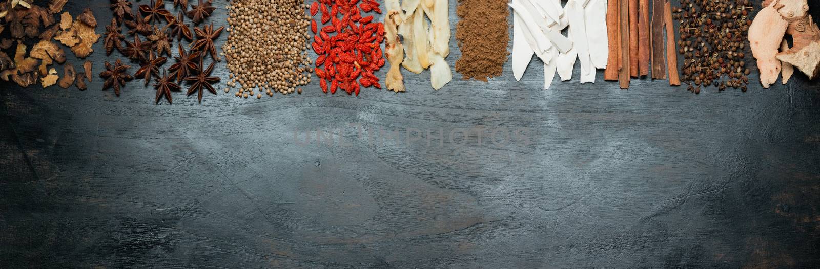 food panorama spices and herbs on black wood background