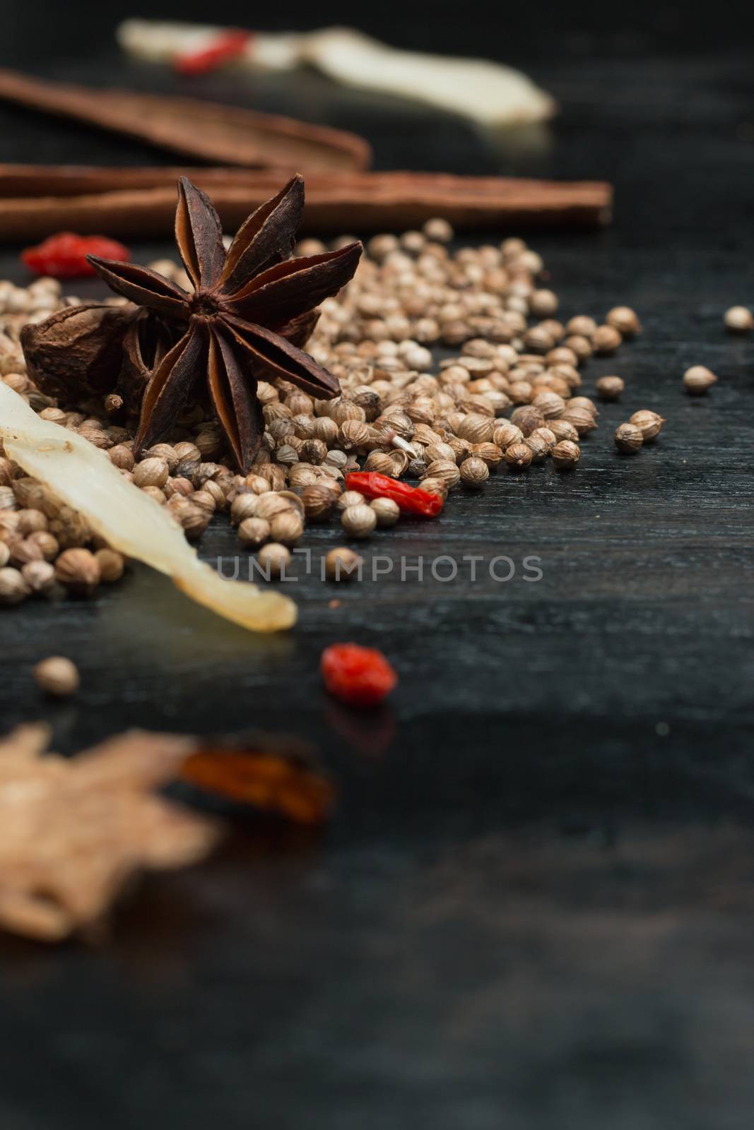 Macro closeup Spices and herbs on black wood background