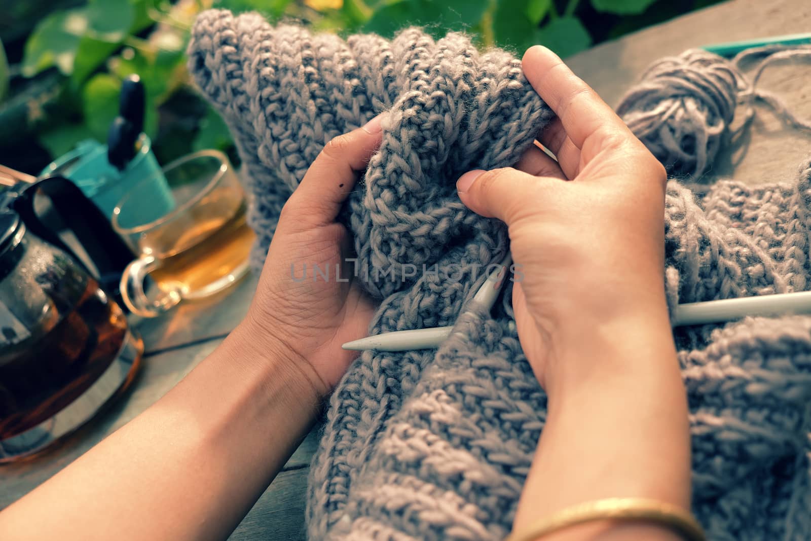 Knit man scarf for cold day in winter, hobby leisure with handmade gift for father day, woman hand knitting from yarn, nice present in vintage color