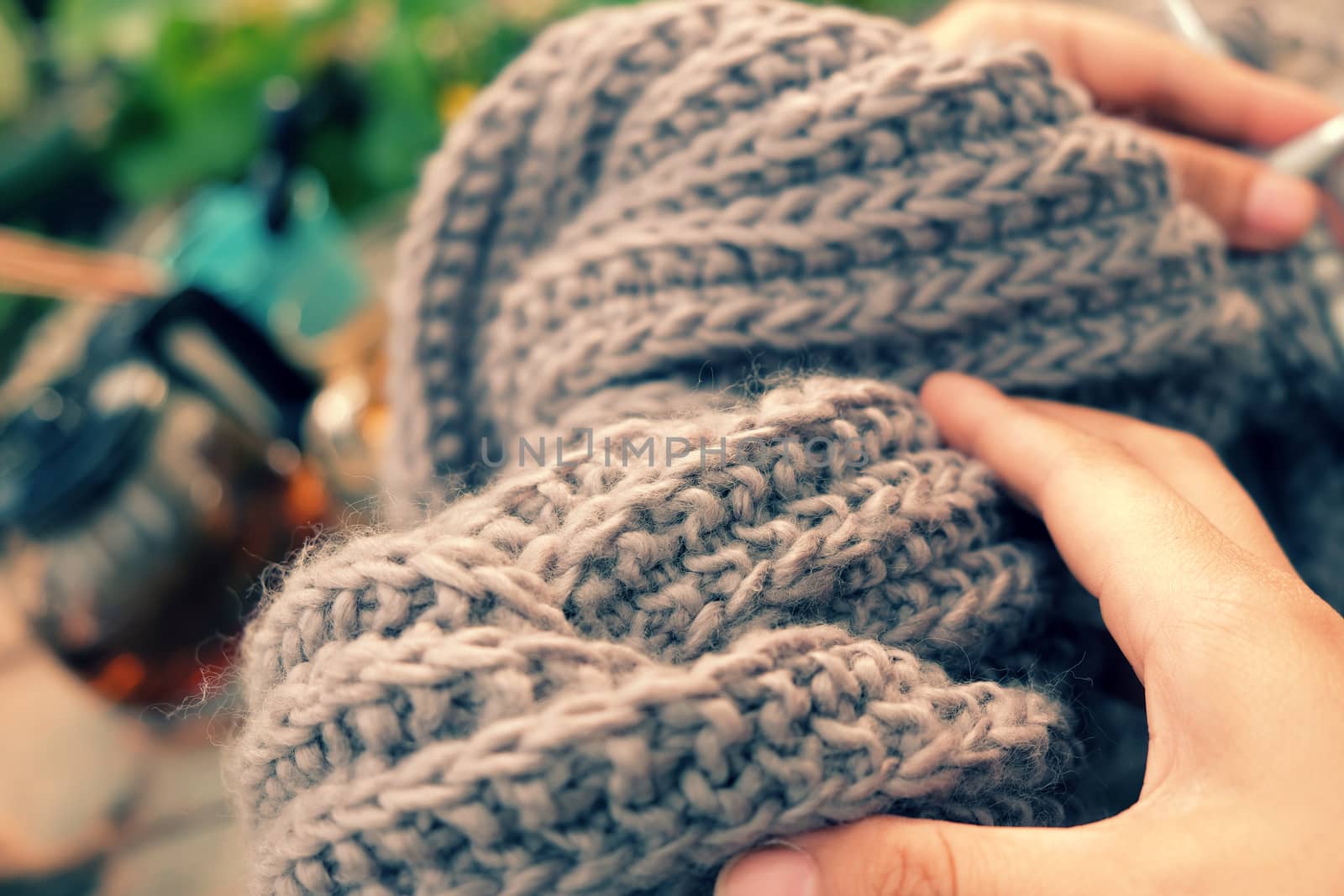 Knit man scarf for cold day in winter, hobby leisure with handmade gift for father day, woman hand knitting from yarn, nice present in vintage color