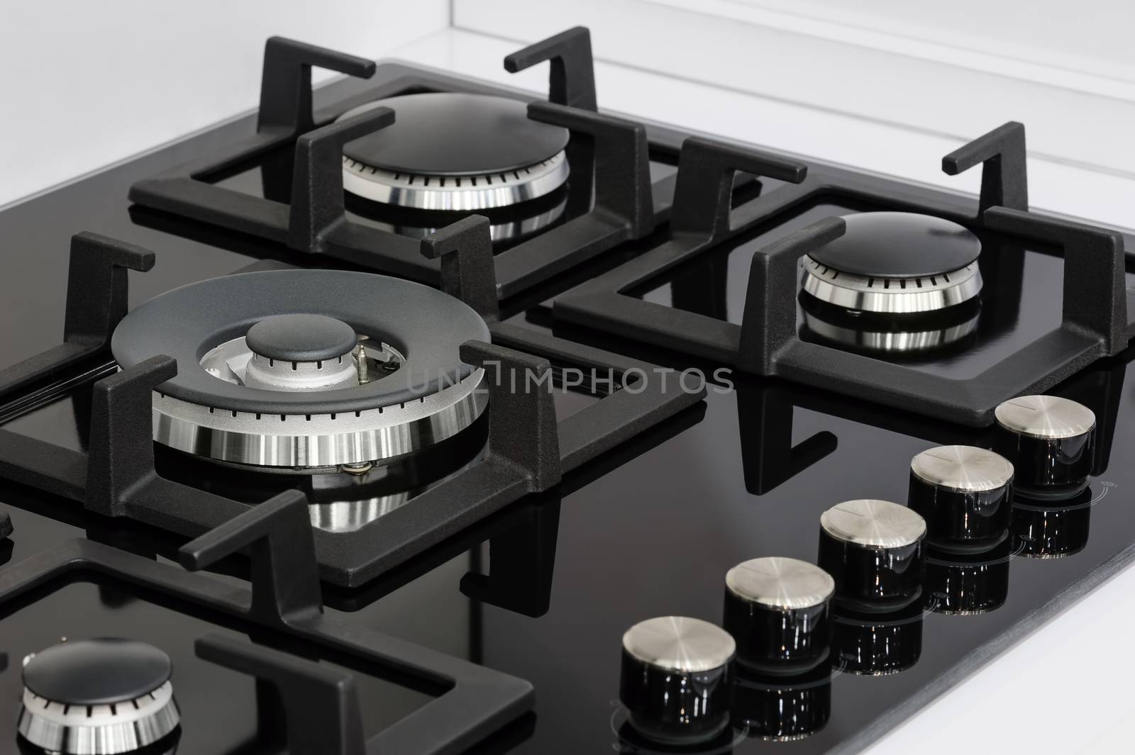 Gas stove with stainless tray selling in appliance retail store, closeup