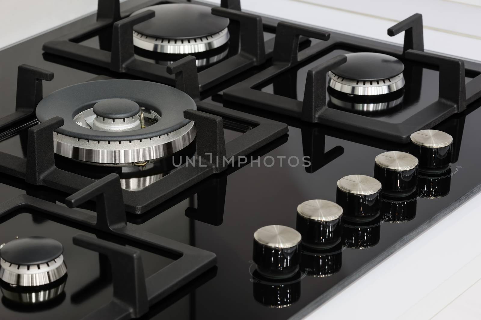 Gas stove with stainless tray selling in appliance retail store, closeup