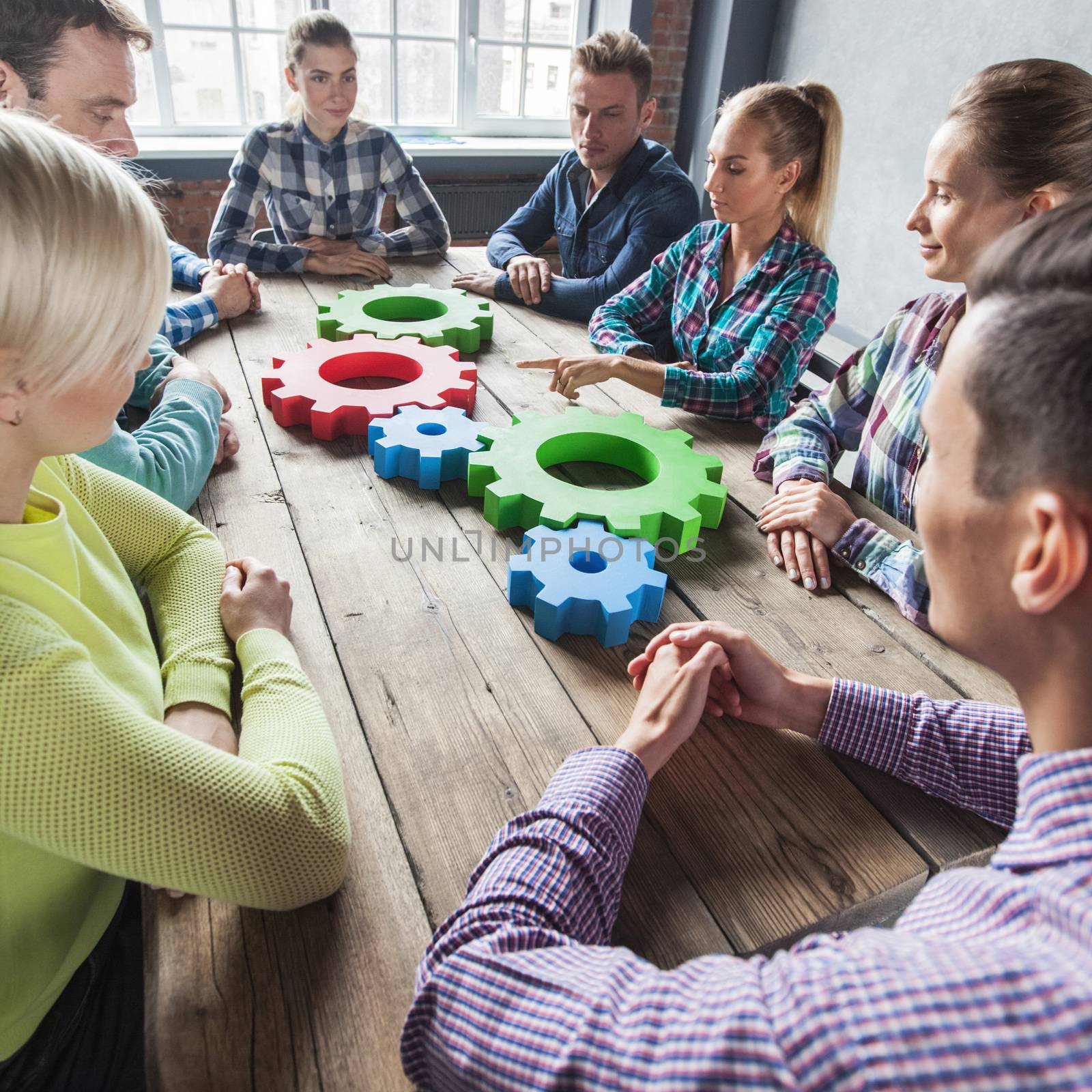 People in casual clothes with cogs of business, modern business meeting concept