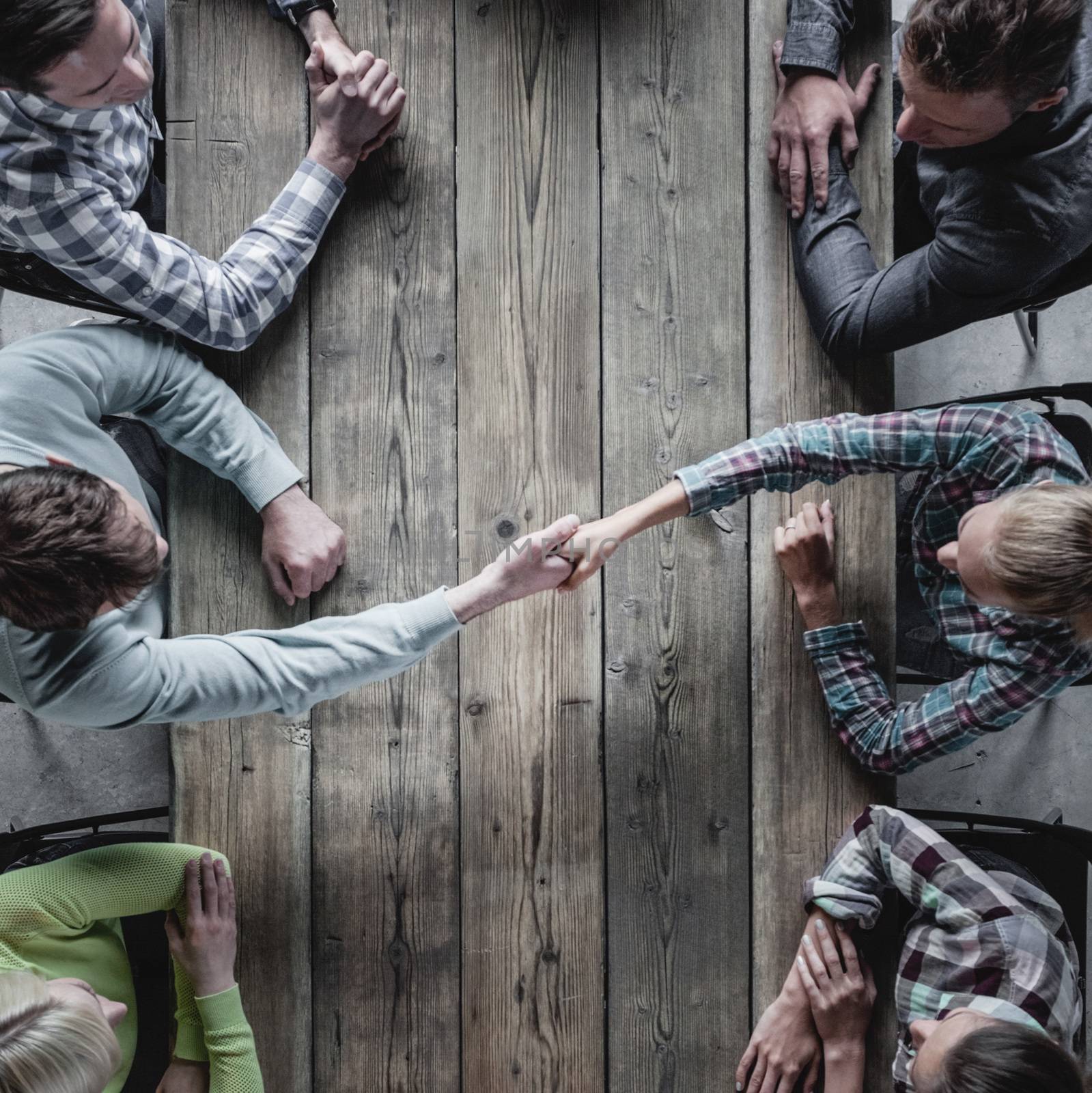 Hipster business people shaking hands, teamwork brainstorming planning meeting concept