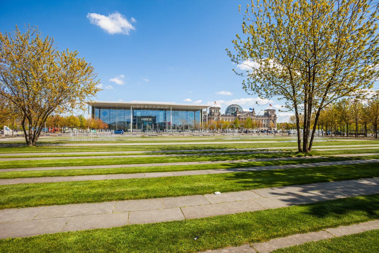 The Paul Loebe Haus and Reichstag in Berlin, Germany with lawn and fountain