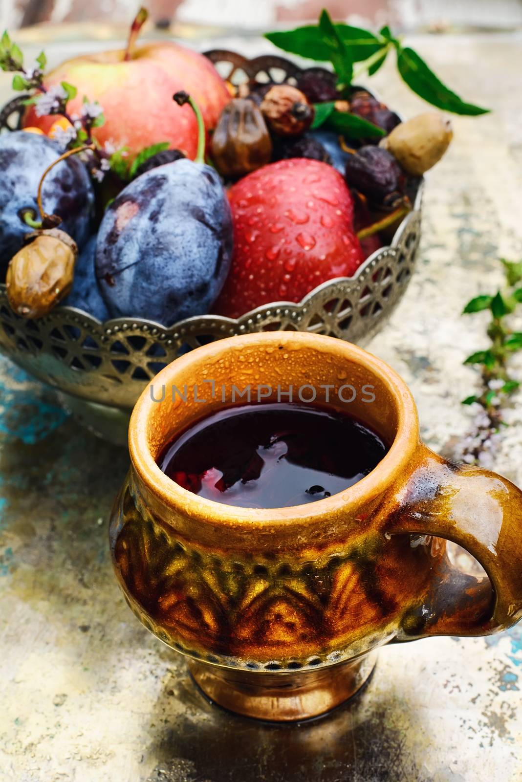 Ceramic cup with compote of autumnal harvest of the orchard