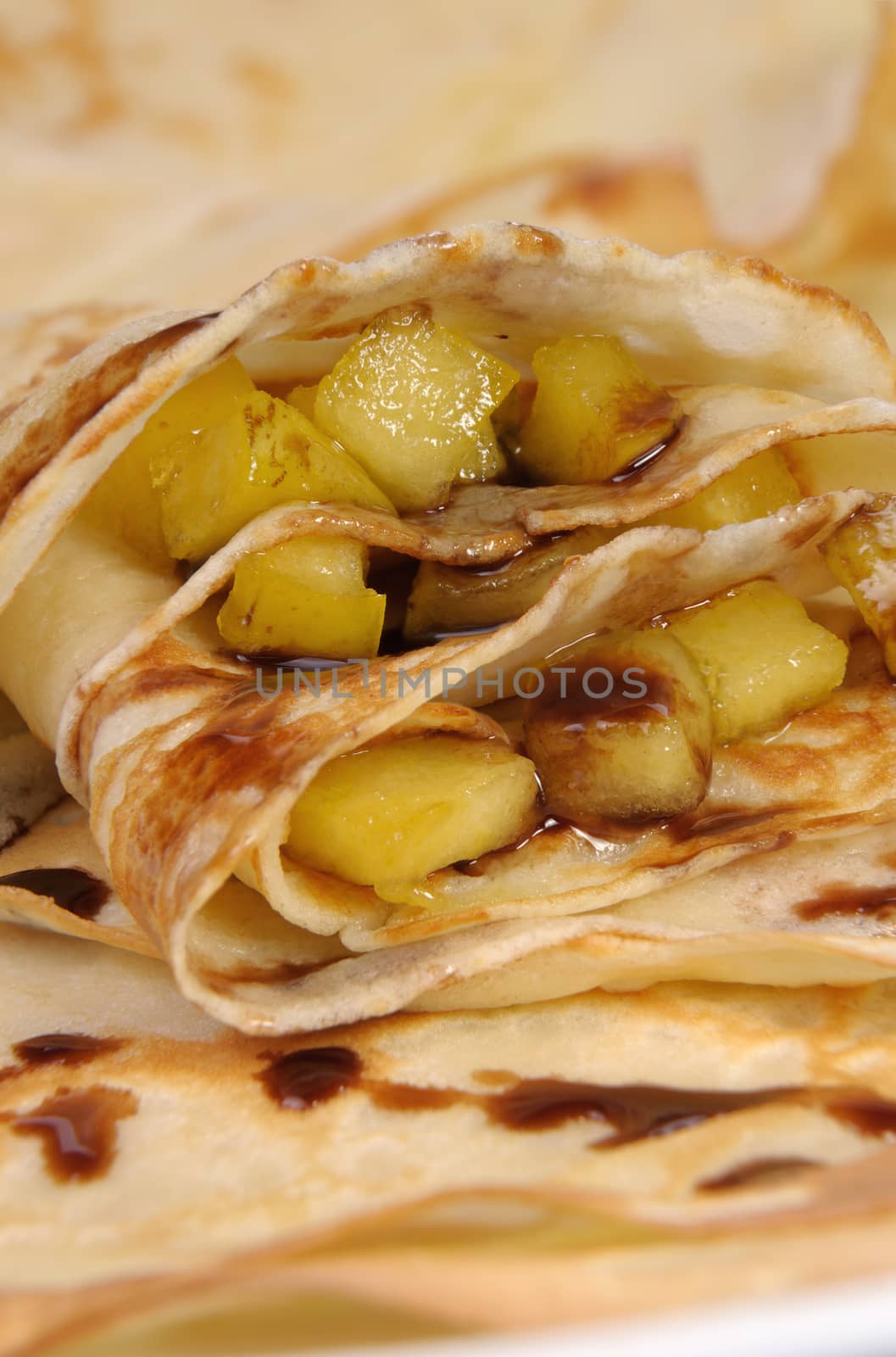 Pancakes sliced apples with caramel and chocolate for breakfast