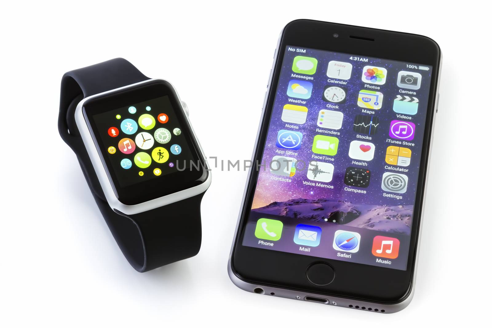 GALATI, ROMANIA - FEBRUARY 17, 2016: Apple Watch Sport 42mm Silver Aluminum Case with Black Sport Band displaying the apps screen next to the iPhone 6s displaying the home screen. The Apple Watch is the latest device