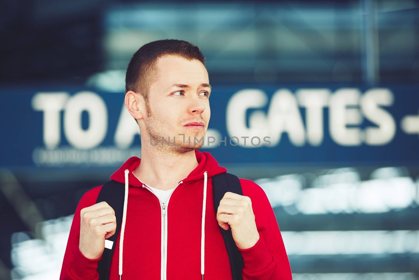 Portrait of the handsome young traveler at the airport 