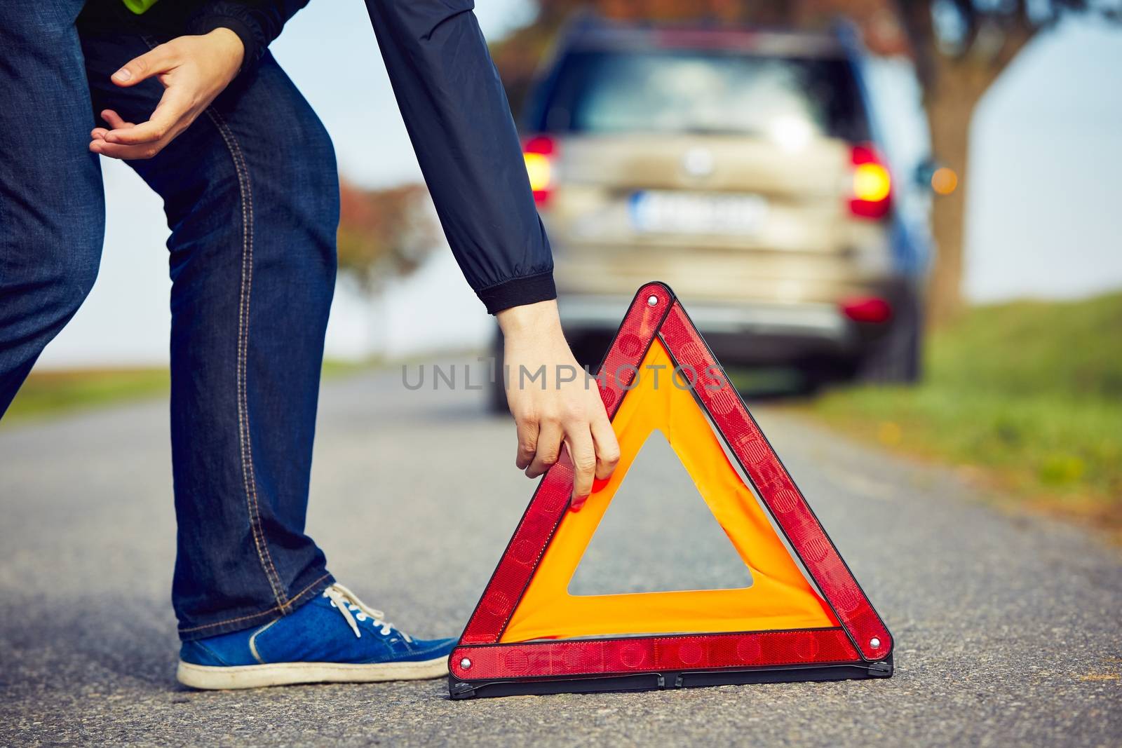 Sad man having car trouble on the country road.