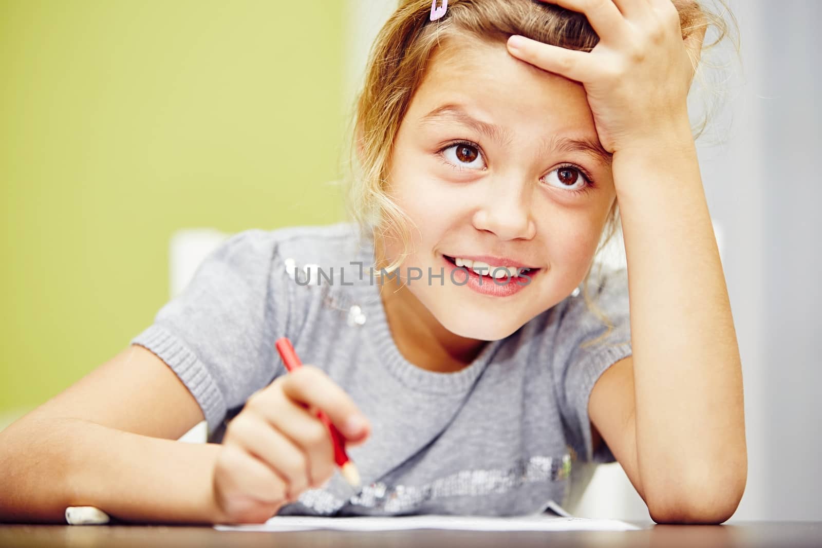 Little girl is doing his homework for elementary school.