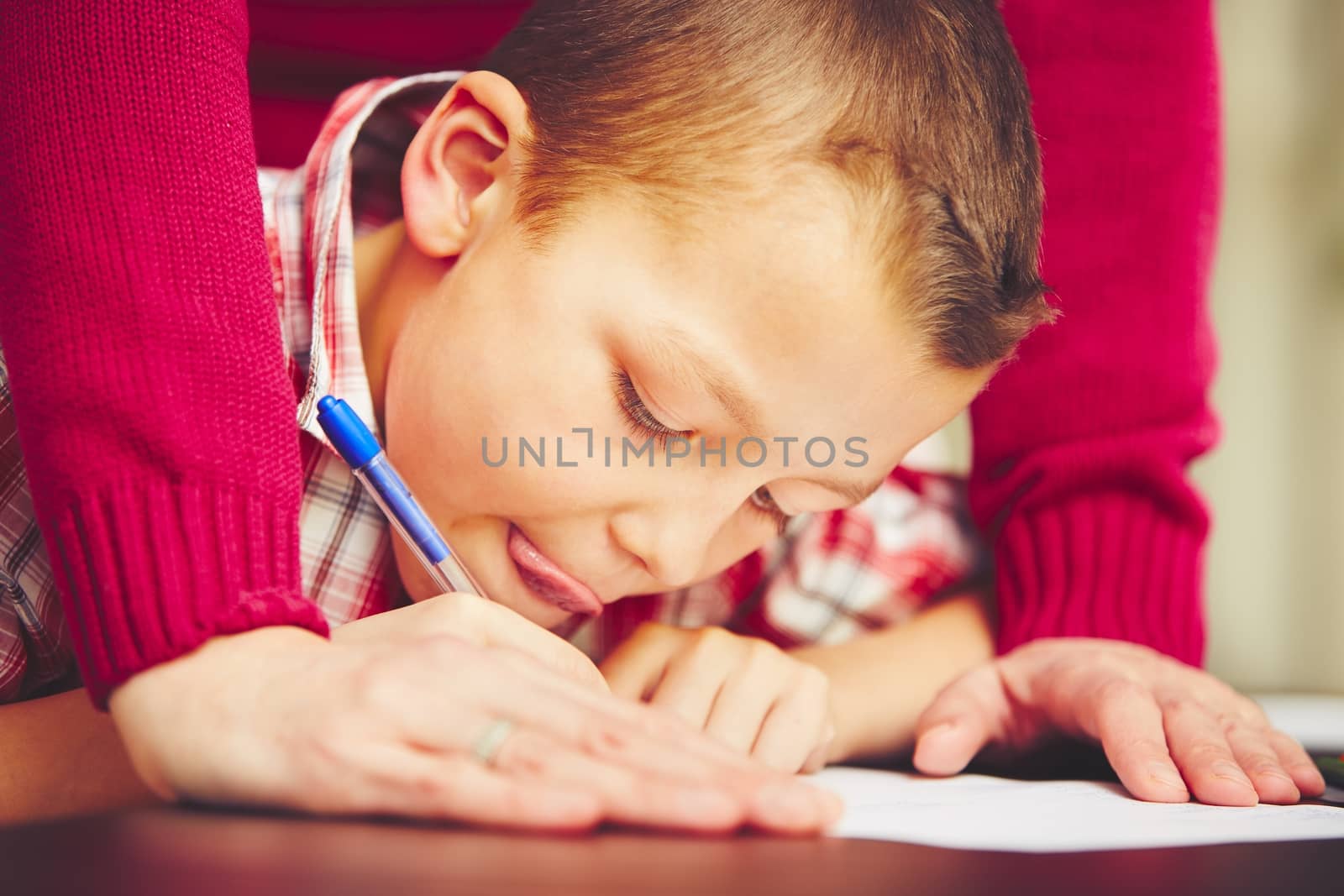Little boy is doing his homework for elementary school.