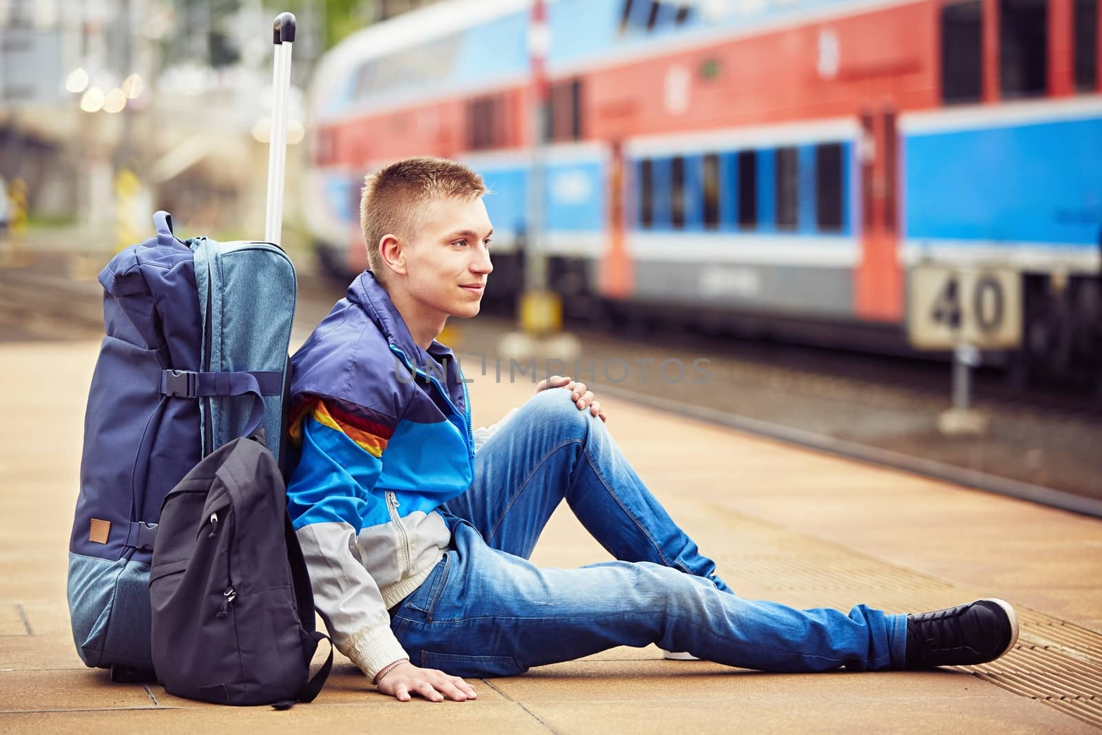 Young traveler is waiting at the railway station