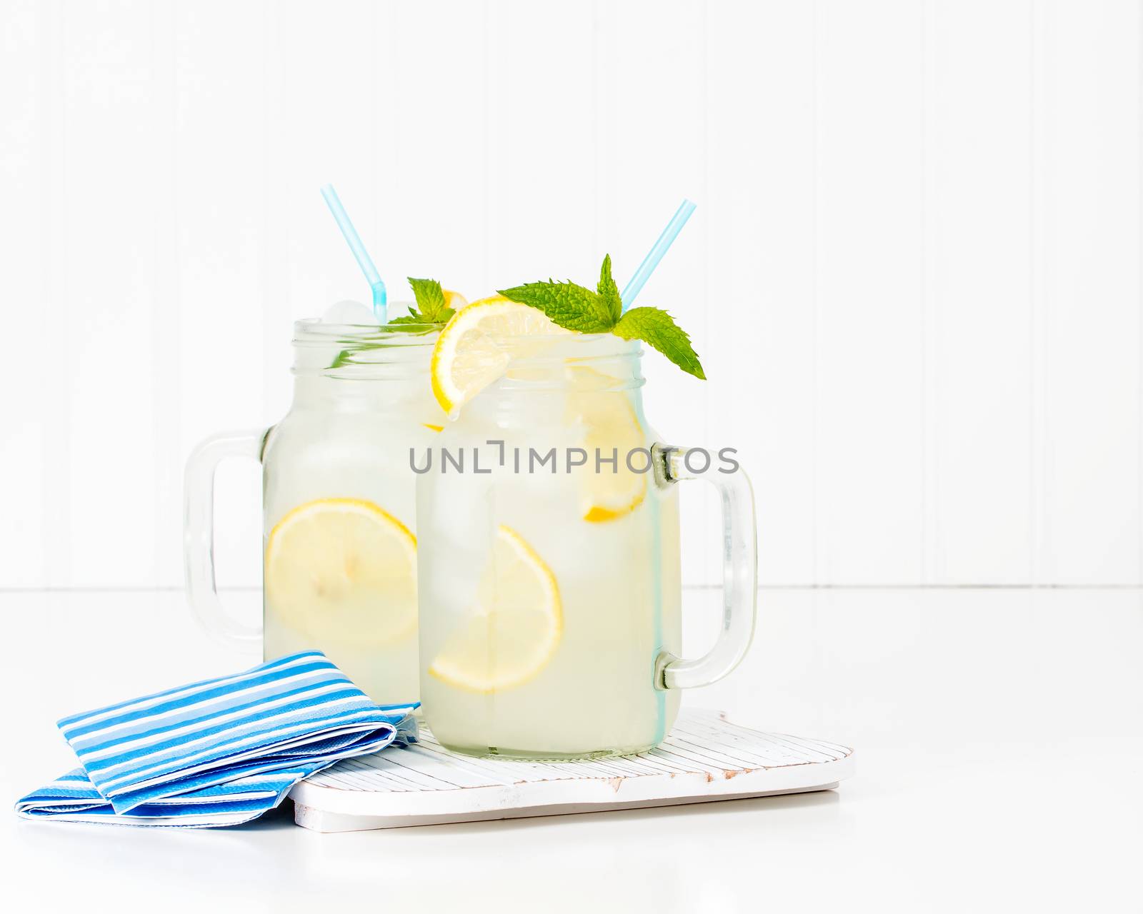 Two jars of ice cold homemade lemonade.