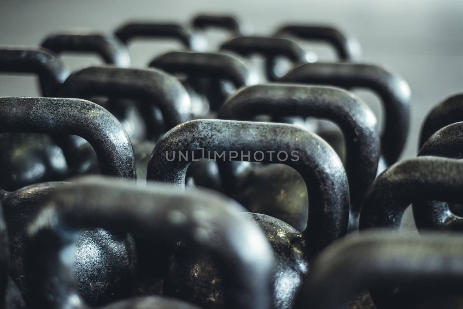 Kettlebells organized and put away at the gym.
