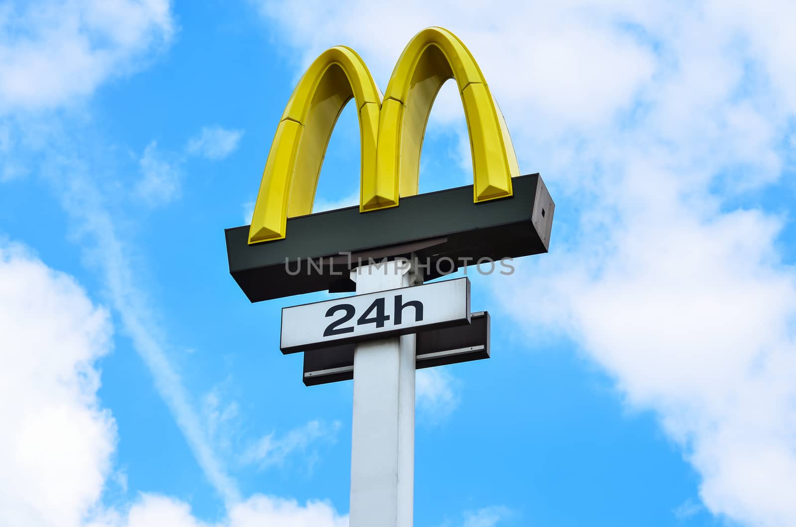 Olsztyn-Poland, 14 June 2016 McDonald's yellow logo advertising sign placed on a pole with a clear blue sky with copy space. Editorial photo