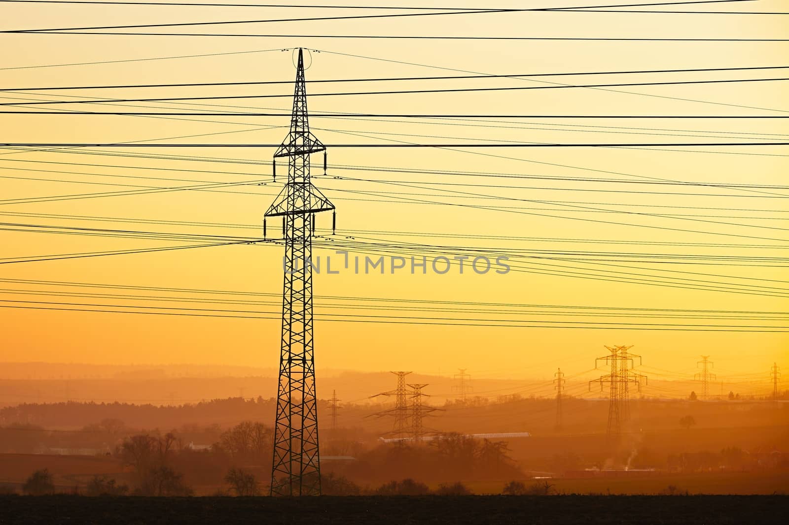 Silhouette electricity pylons during sunset - Czech Republic