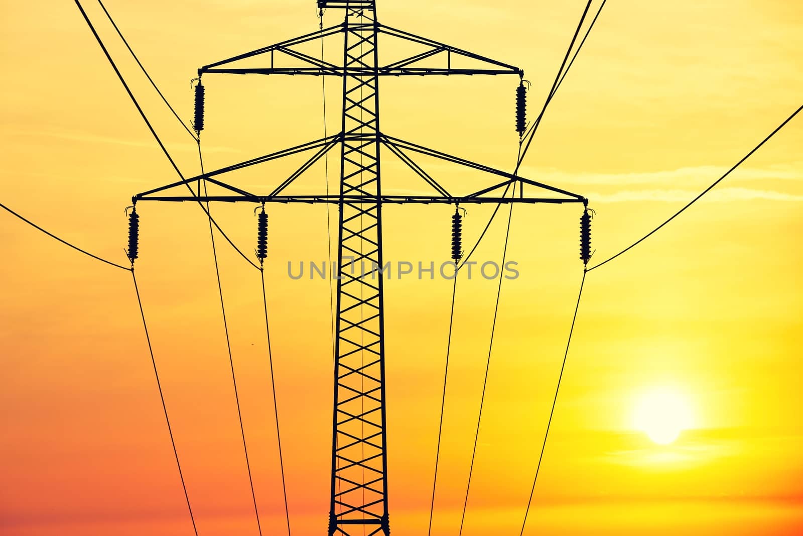 Silhouette of the electricity pylon at the sunrise