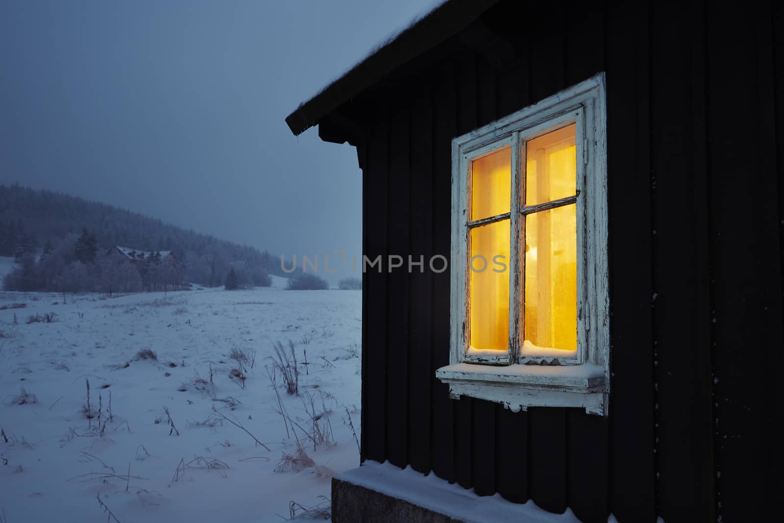 Night in mountains - wooden house in winter landscape 