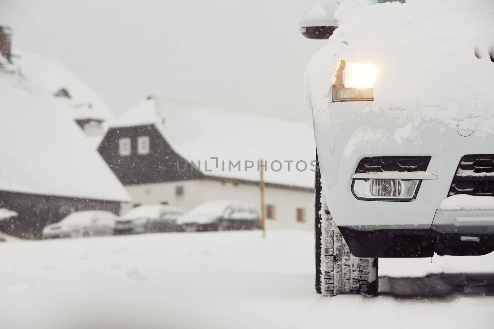 Head light of the car on winter road