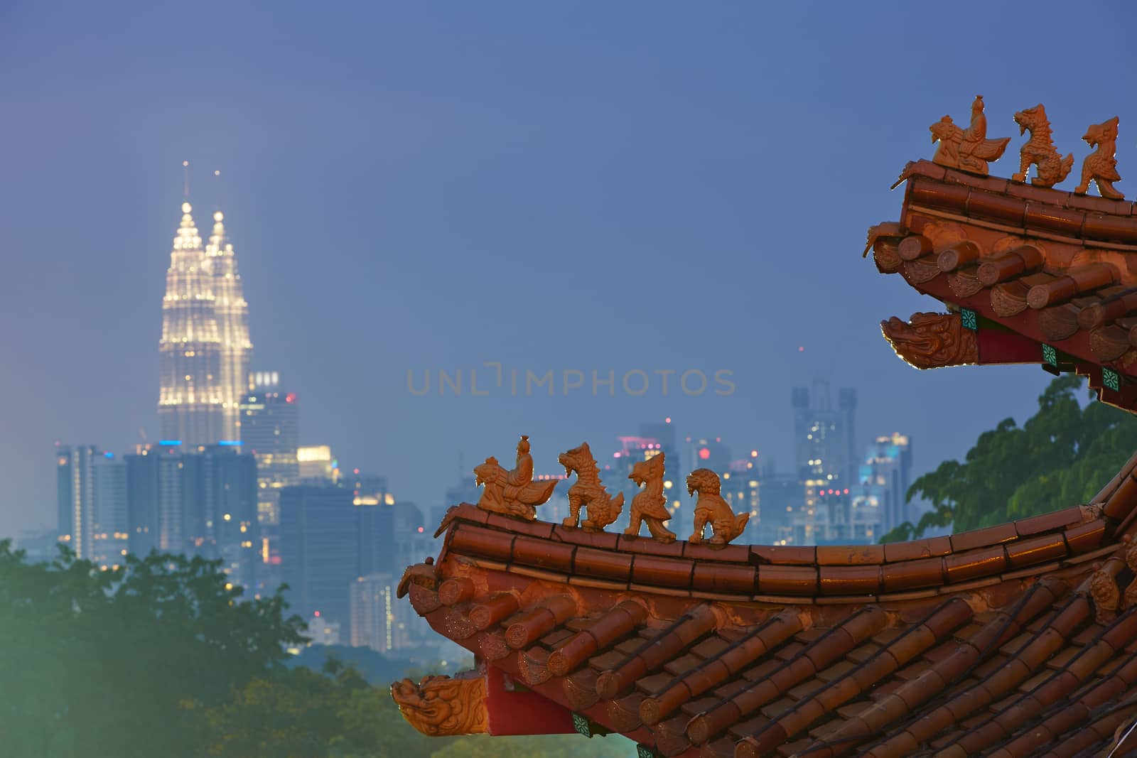 Roof of the chinese temple overlooking Petronas twin towers in Kuala Lumpur.