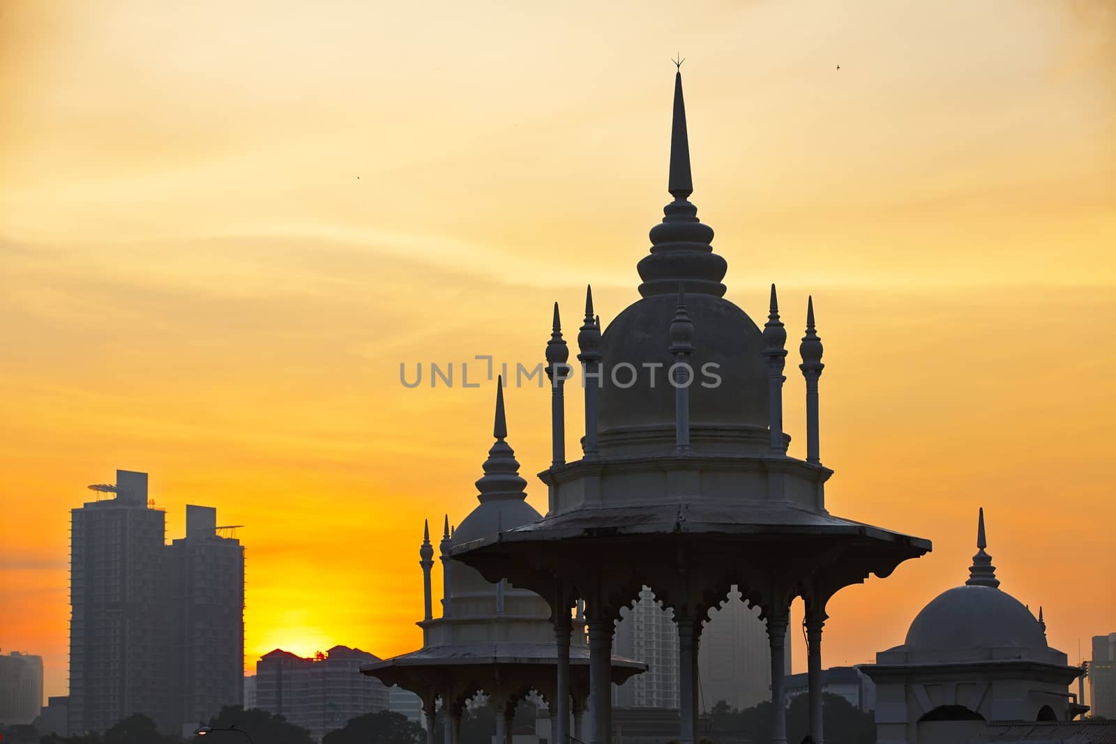 Towers of the historical building railway station in Kuala Lumpur at sunrise.