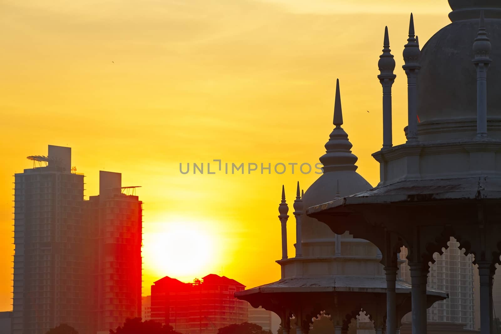 Towers of the historical building railway station in Kuala Lumpur at sunrise.