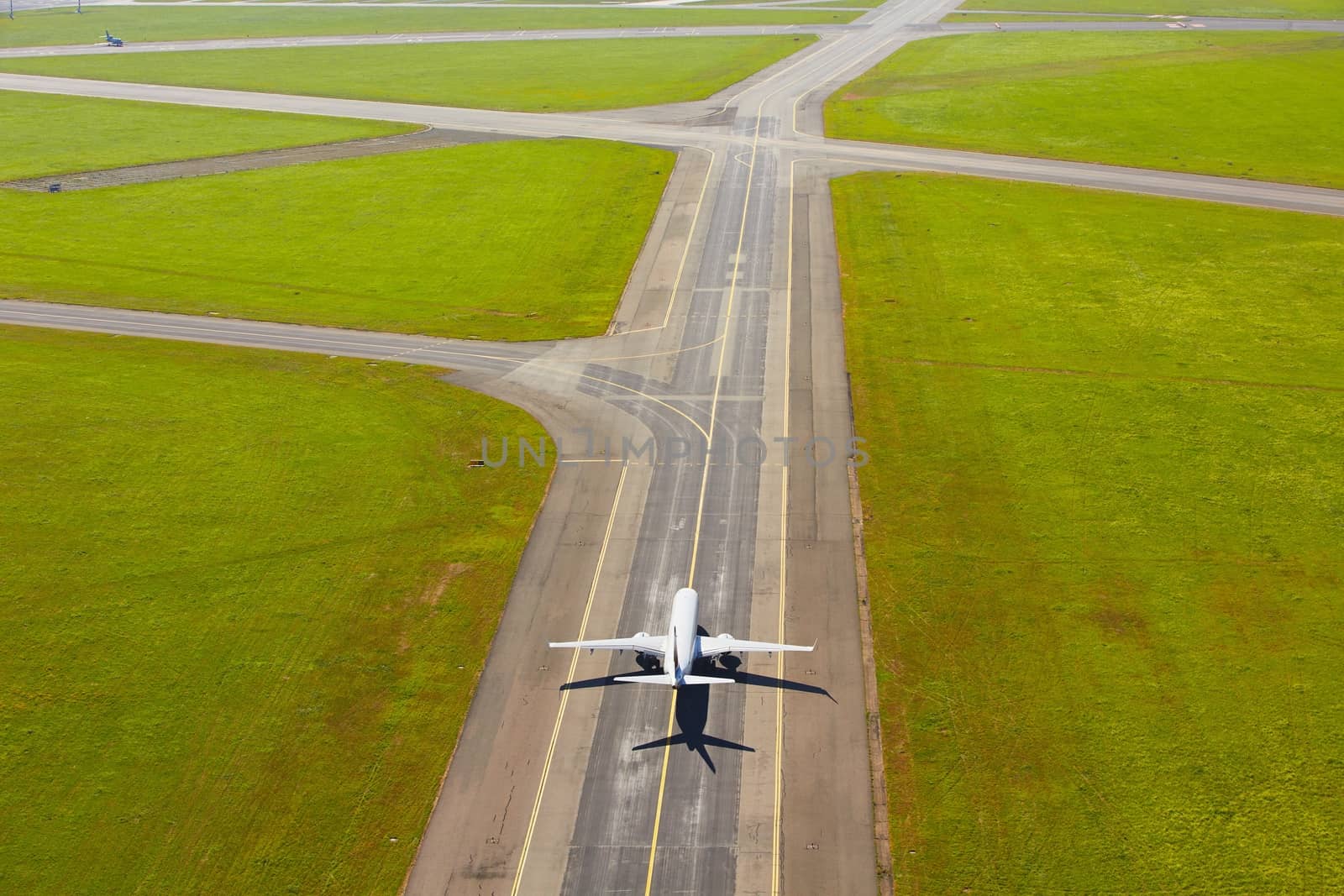 Aerial view of airport - airplane is taxiing to take off