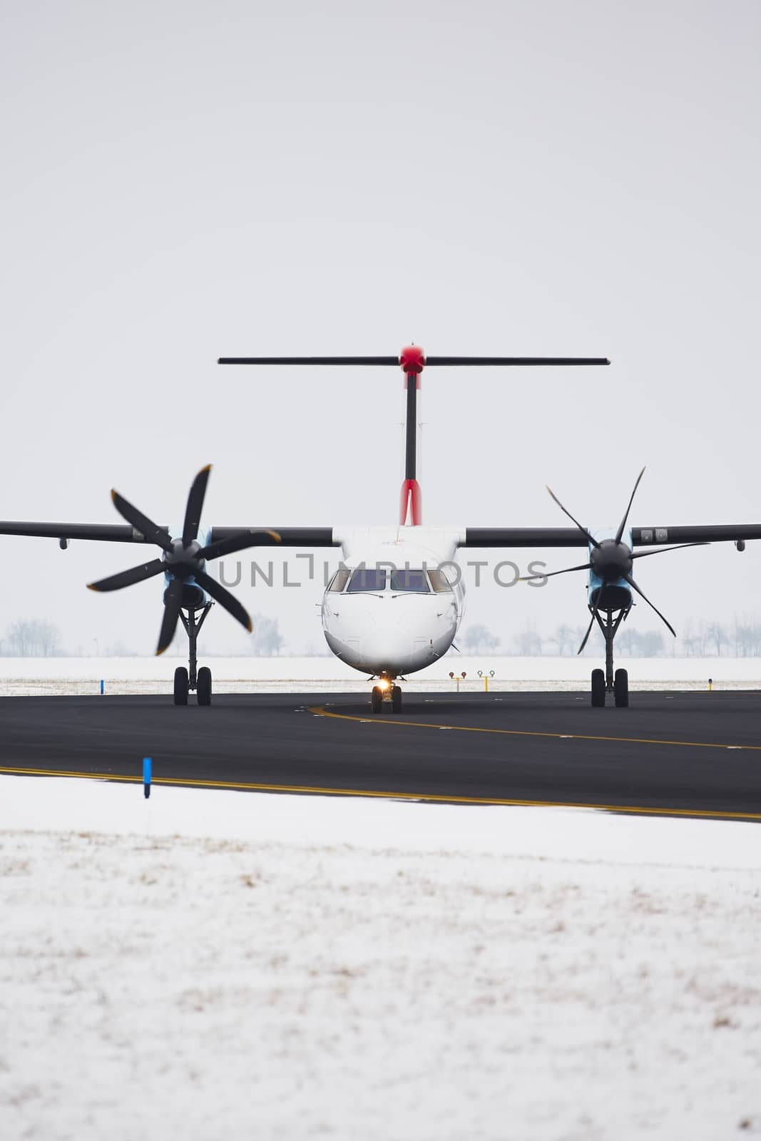 Airplane is taxiing on the airport in winter.