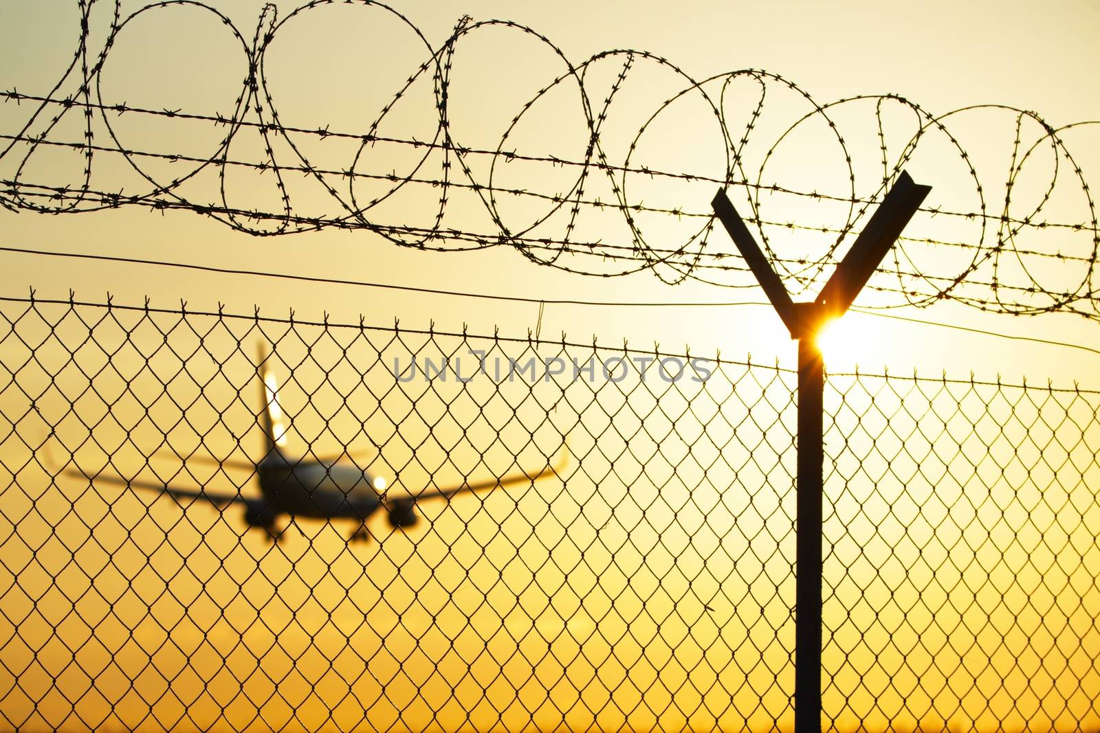 Airport at the sunset - security system