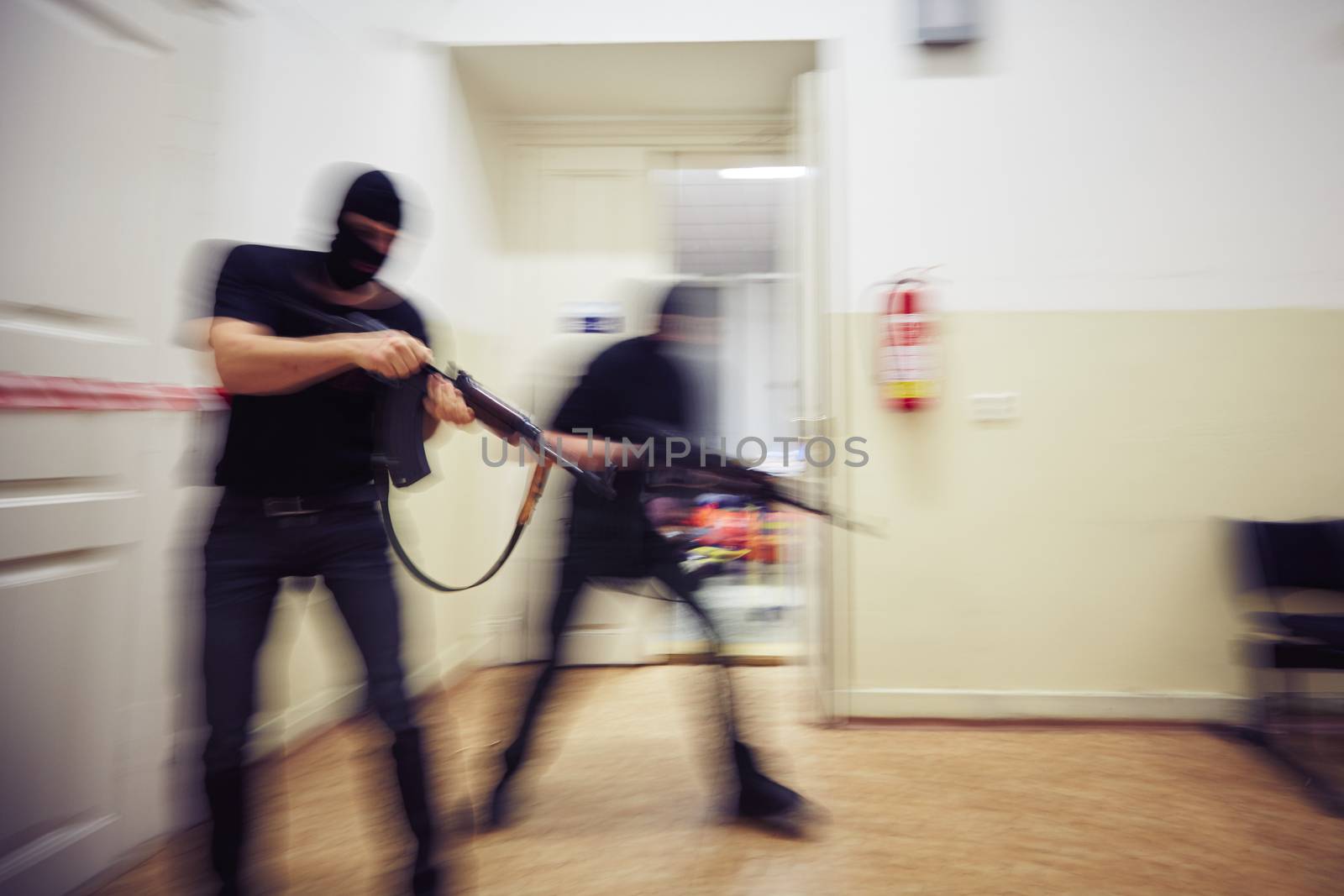 Two terrorists with rifles in the building - defocused