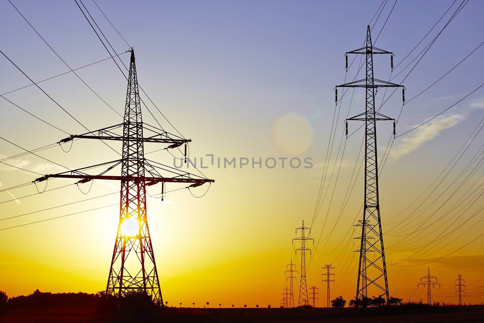High voltage - electric power lines at the sunset