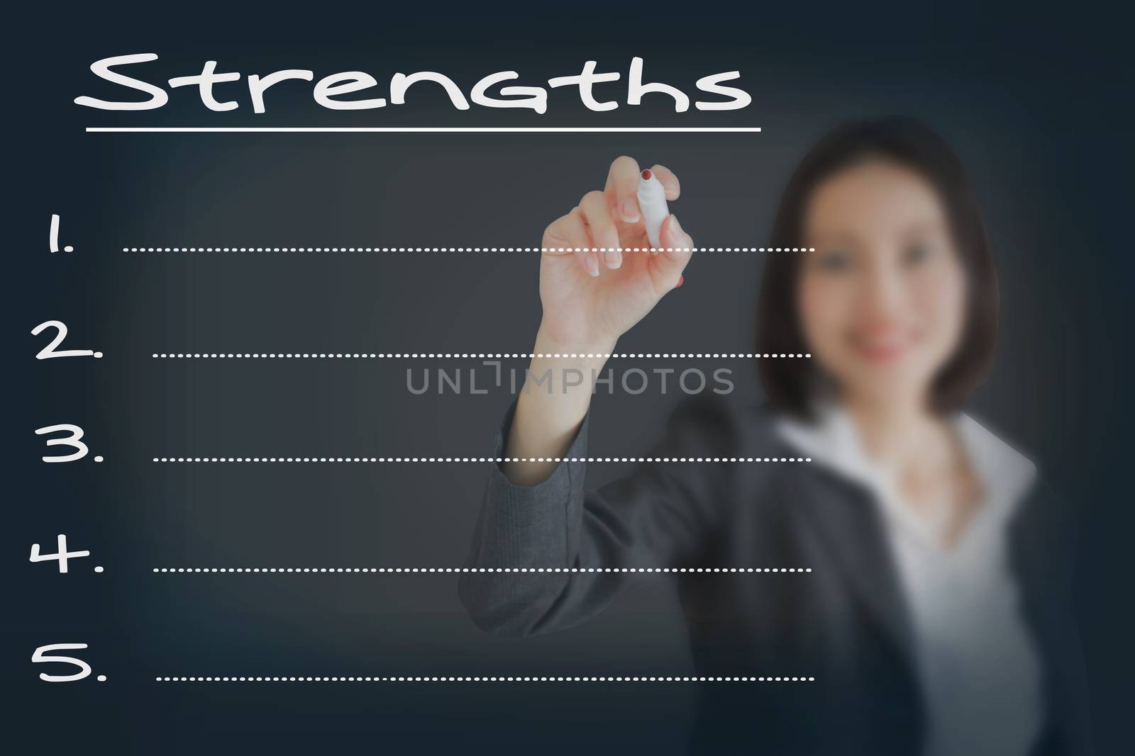 Beautiful businesswoman writing list of business strength 