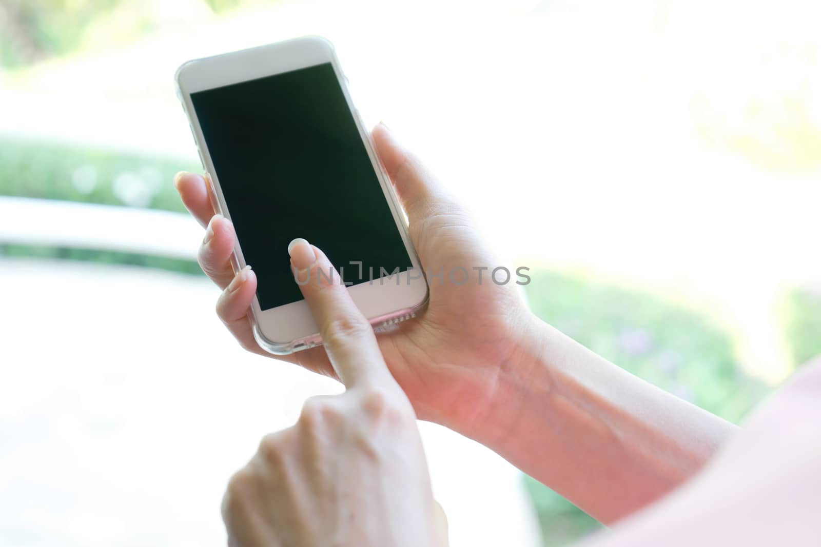 Closeup image of a female hands using smartphone