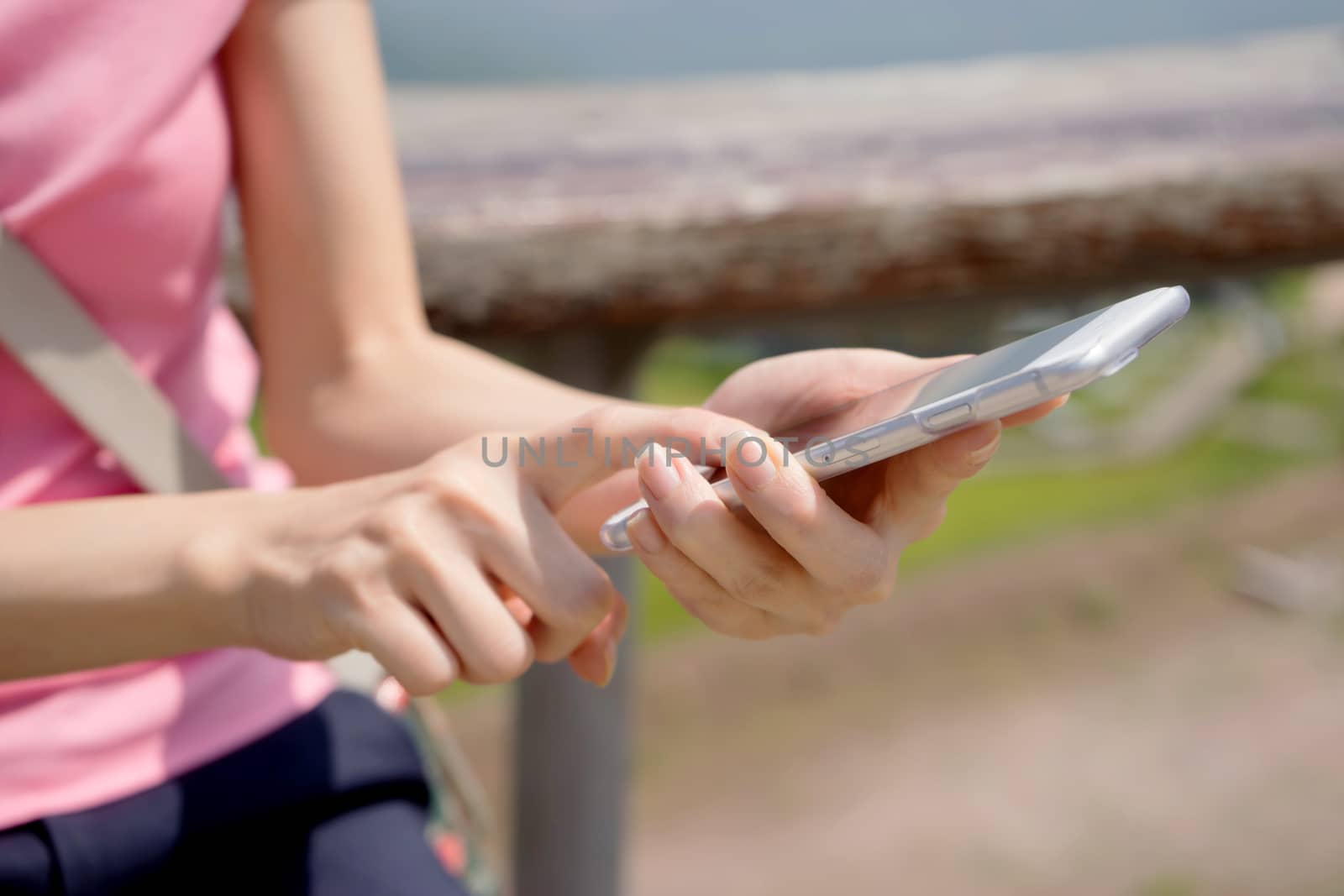 Woman sending a text from her mobile phone