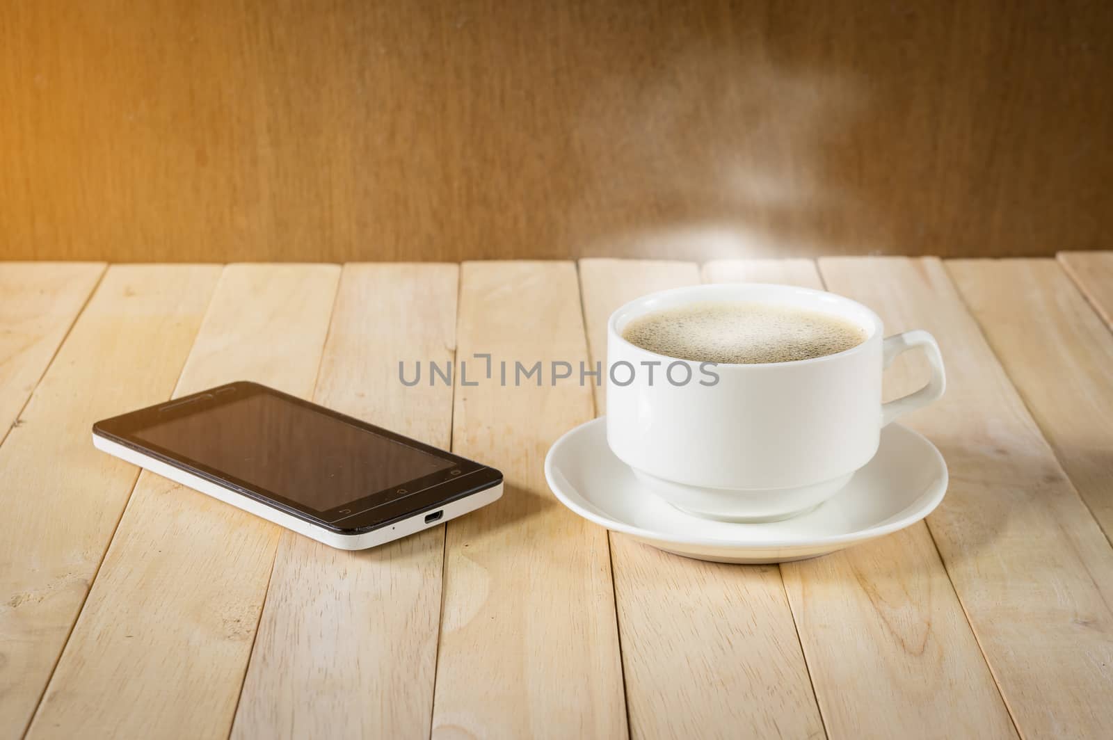 warm cup of coffee on wood background.