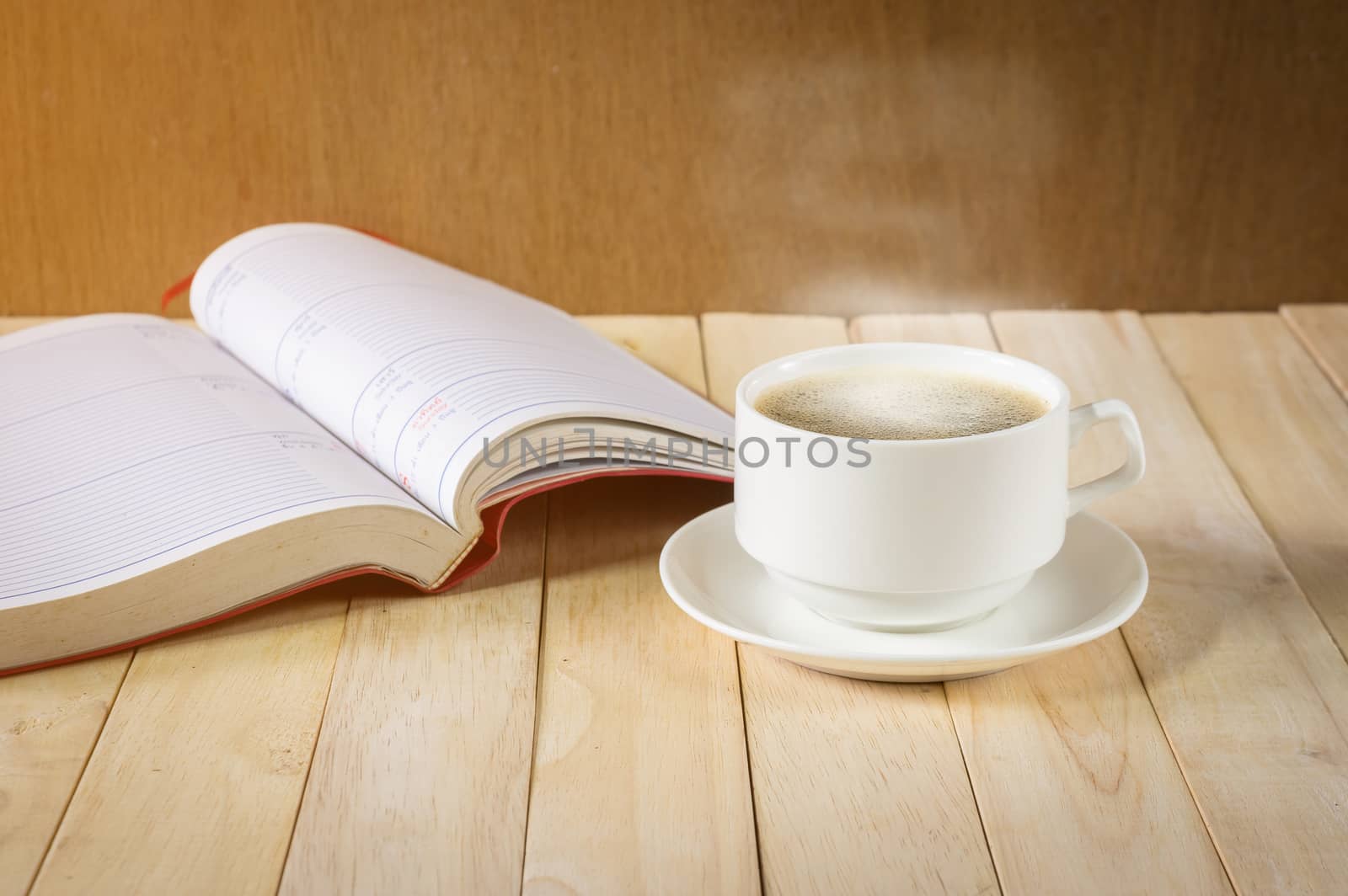 warm cup of coffee on wood background.