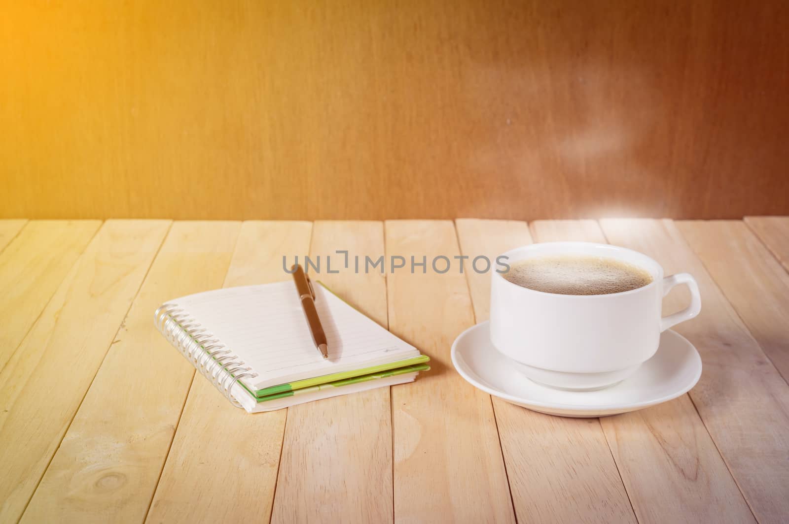 warm cup of coffee on wood background.