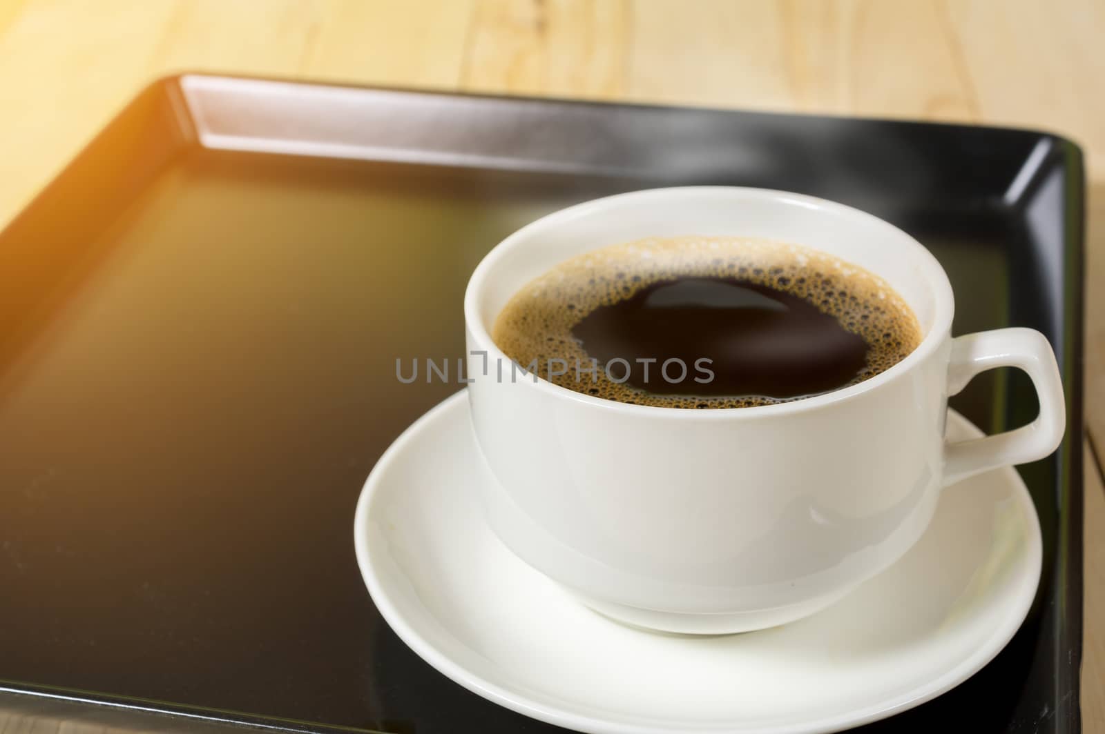 warm cup of coffee on wood background.