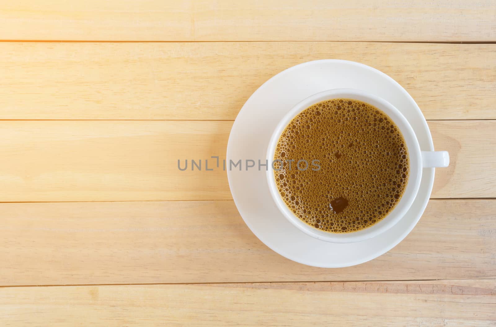 Cup of coffee on wood background.