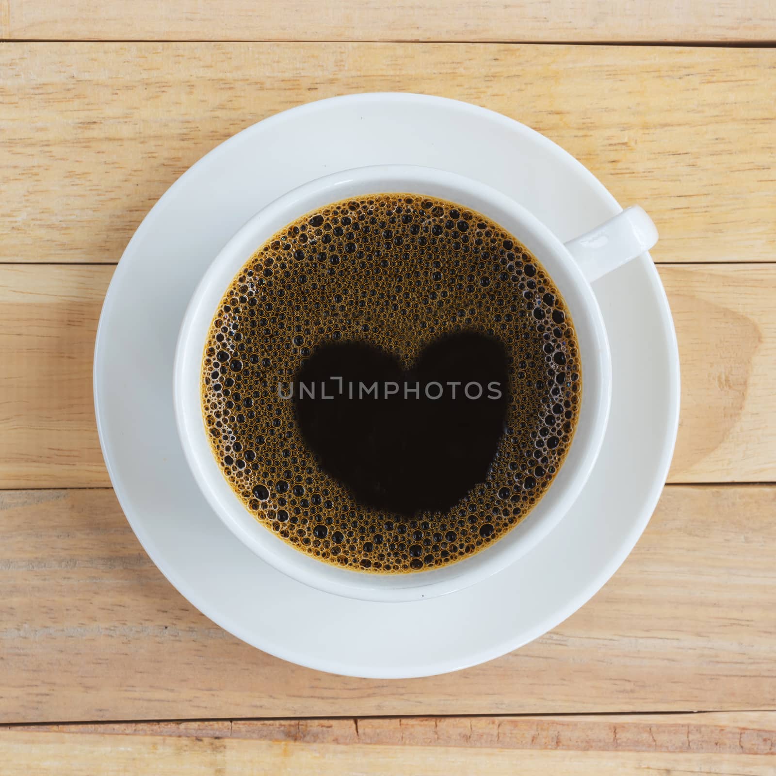 Cup of coffee on wood background.