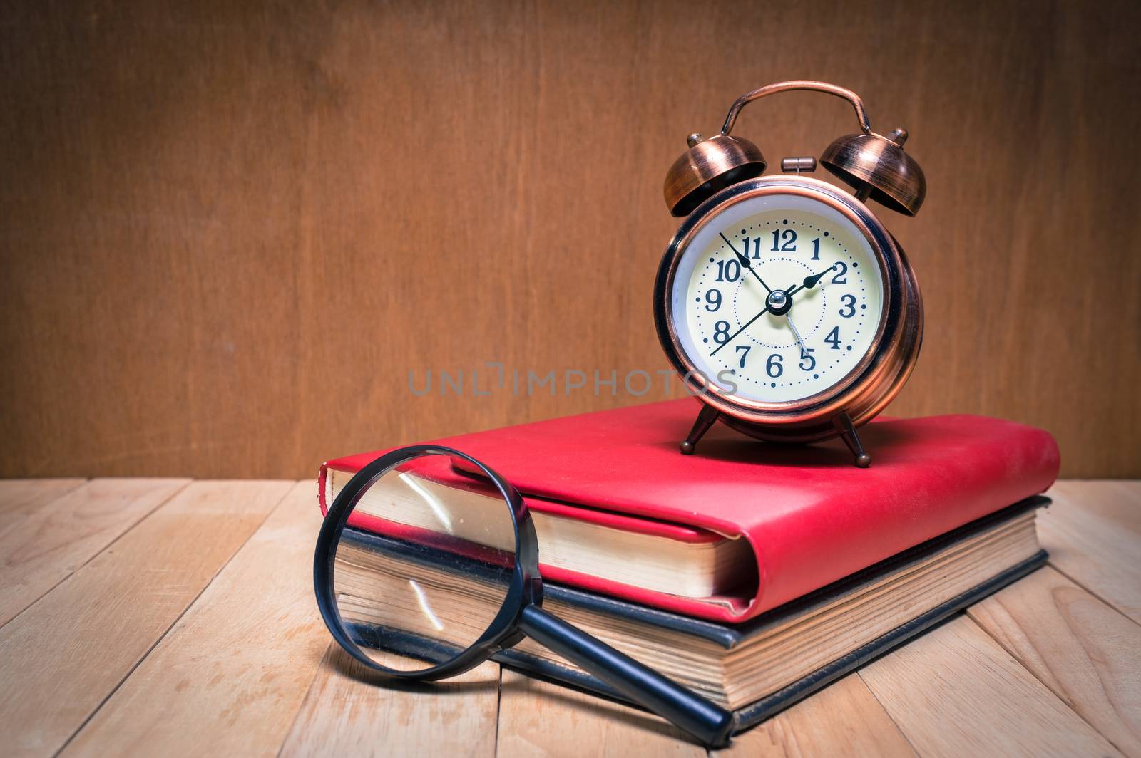 Retro alarm clock and book with magnifier.