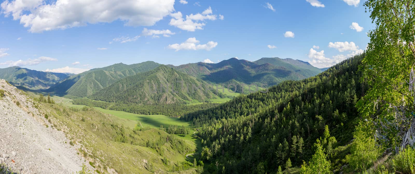 Summer view of mountain valley, under blue sky with clouds. Western Siberia, Altai mountains