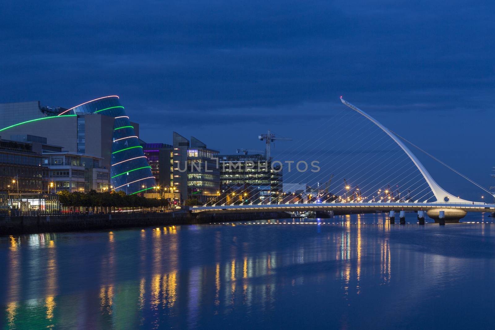 The River Liffey, the Samuel Beckett Bridge and the building on the waterfront near the Convention Center - Dublin city center in the republic of Ireland.