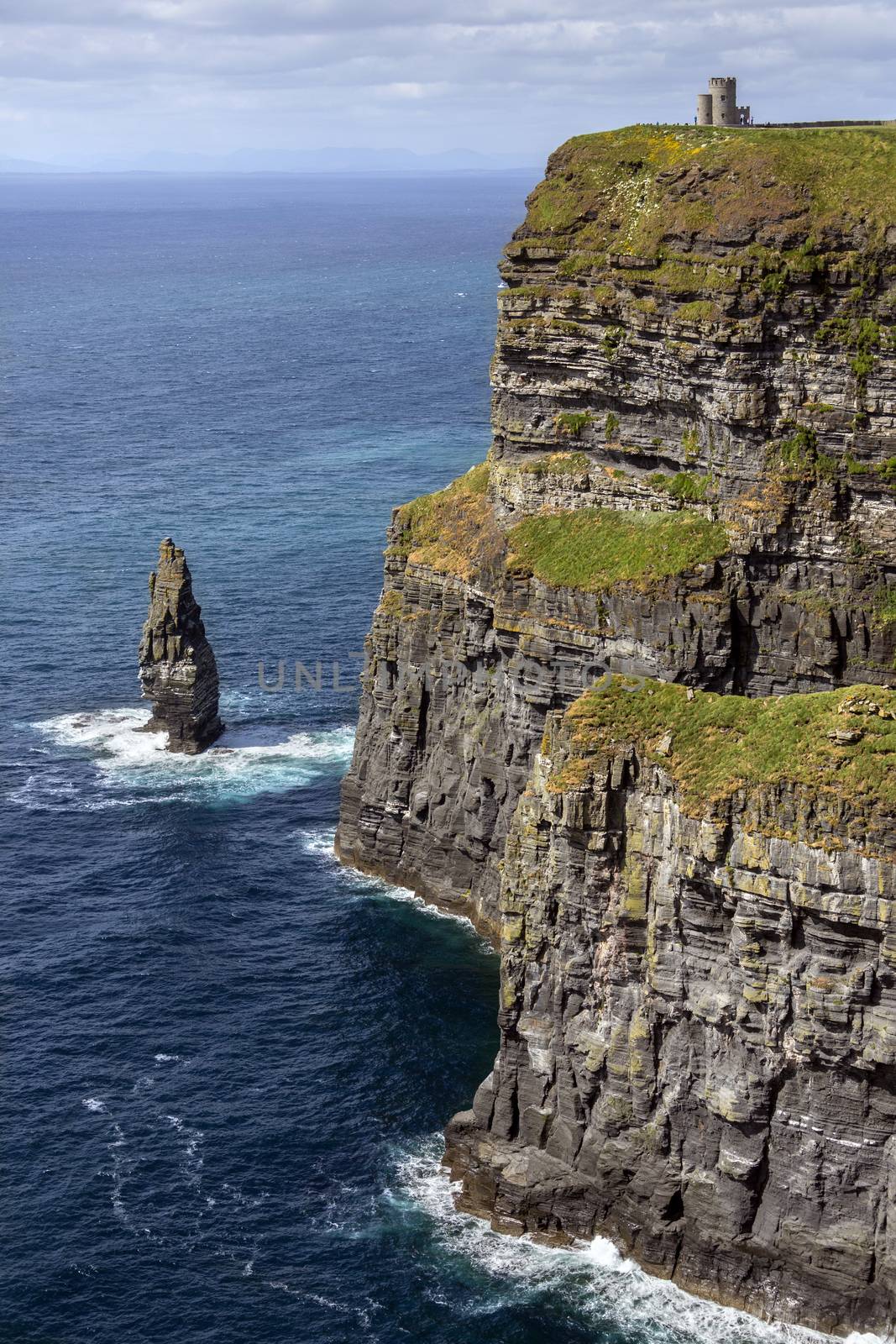 The Cliffs of Moher - located at the southwestern edge of the Burren region in County Clare, Ireland. They rise 120 metres (390 ft) above the Atlantic Ocean at Hag's Head and reach their maximum height of 214 metres (702 ft) here just north of O'Brien's Tower which can be seen on the cliff top.