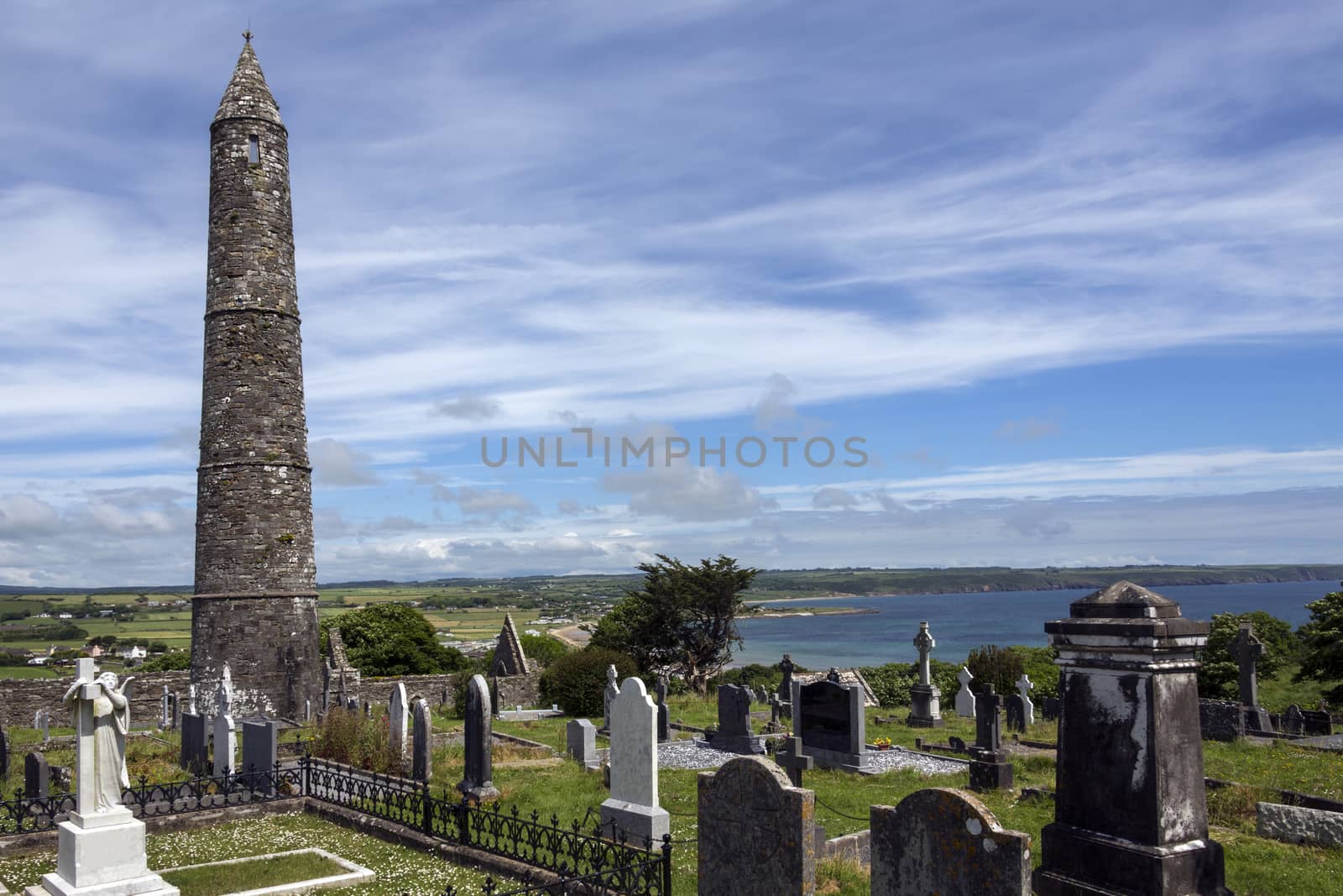 The ruins of Ardmore Cathedral and round tower, County Waterford in the Republic of Ireland. On a hill above the village of Ardmore is a well-preserved 30m, 12th-century round tower and the ruins of a Cathedral dating from the 13th and and an oratory dating from the 8th centuries. The outer walls of the Cathedral features some stone carvings retrieved from an earlier 9th century building. The carvings include a very early image of a harp, images of Adam and Eve in the garden and a representation of Solomon's judgement.