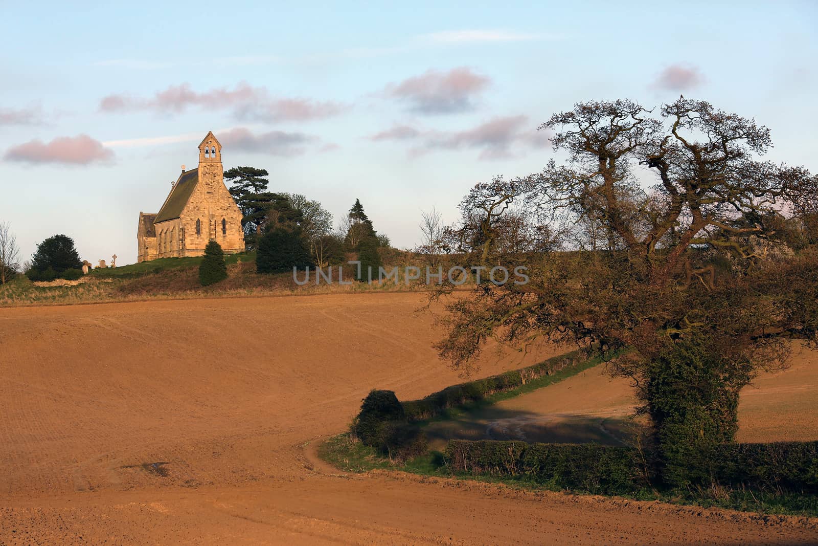 Late afternoon sun on an English Parish Church near the village of Leavening in the countryside of North Yorkshire in northeast England.