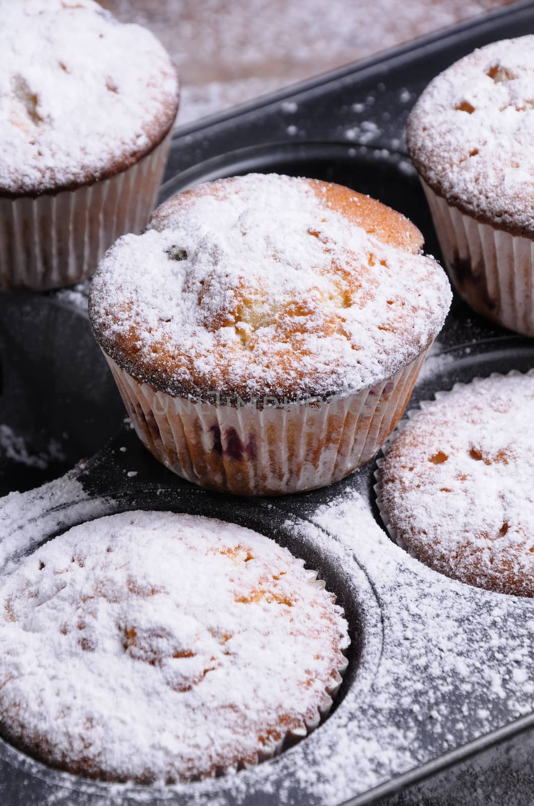 Muffins with filling in the sugar powder in the pan